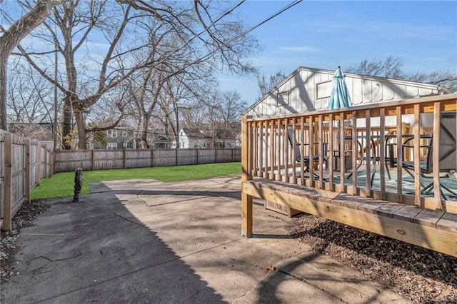 view of patio featuring a deck and a fenced backyard