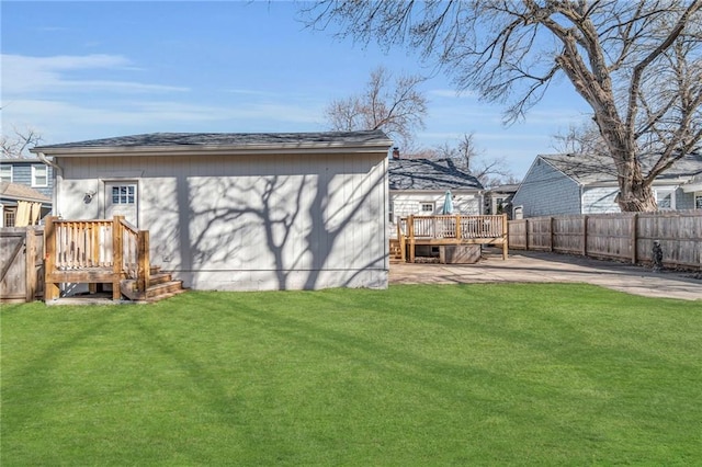 back of property with a yard, a patio, a wooden deck, and a fenced backyard