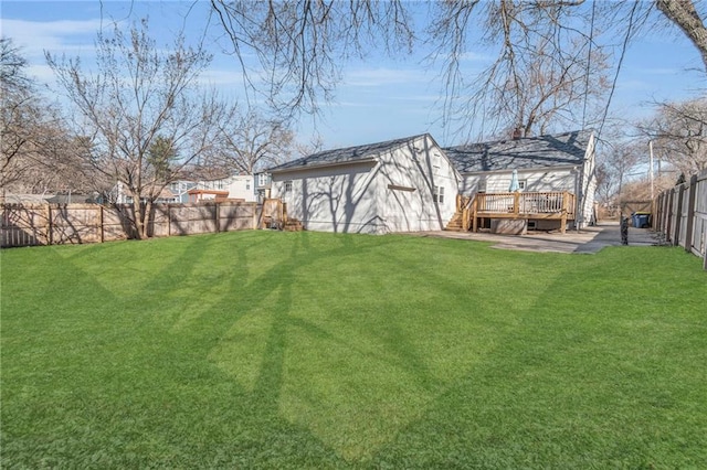 view of yard with a deck and a fenced backyard