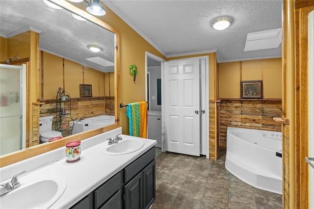 bathroom with a sink, a textured ceiling, a bath, and double vanity