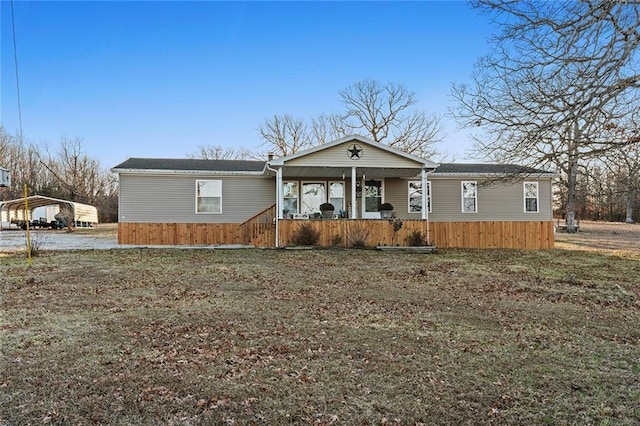 manufactured / mobile home featuring a detached carport and a porch