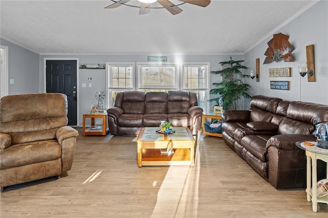 living area featuring crown molding, a ceiling fan, and wood finished floors