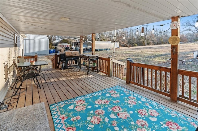 wooden terrace featuring a grill