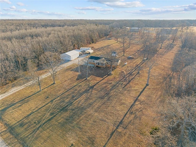 aerial view featuring a view of trees and a rural view