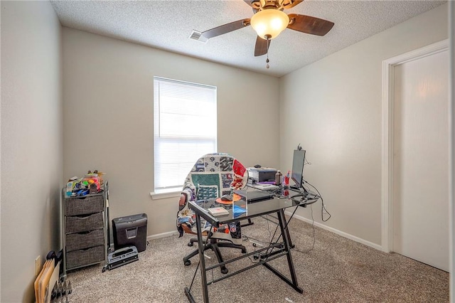 office space with baseboards, carpet, visible vents, and a textured ceiling