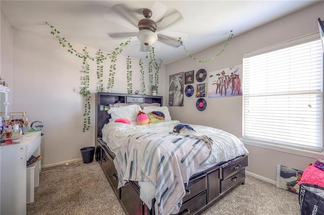 bedroom with baseboards, light colored carpet, and a ceiling fan