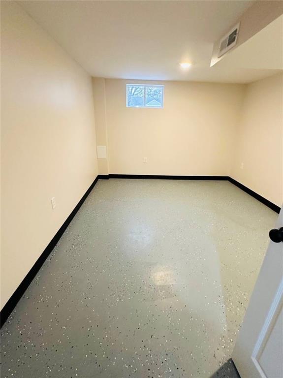 basement featuring visible vents and baseboards