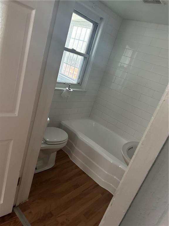 480 Wallace Ave, Kansas City, MO 64125 - full bath featuring a bath, toilet, and wood finished floors