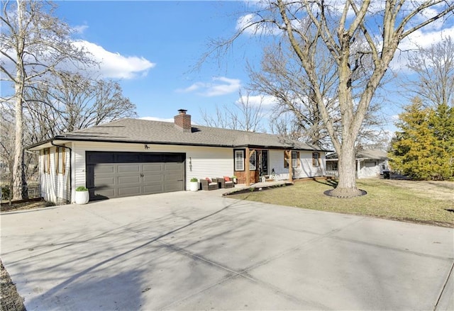 ranch-style home with a shingled roof, concrete driveway, an attached garage, a front yard, and a chimney