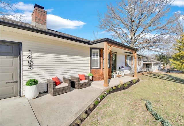 back of property with a yard and a chimney