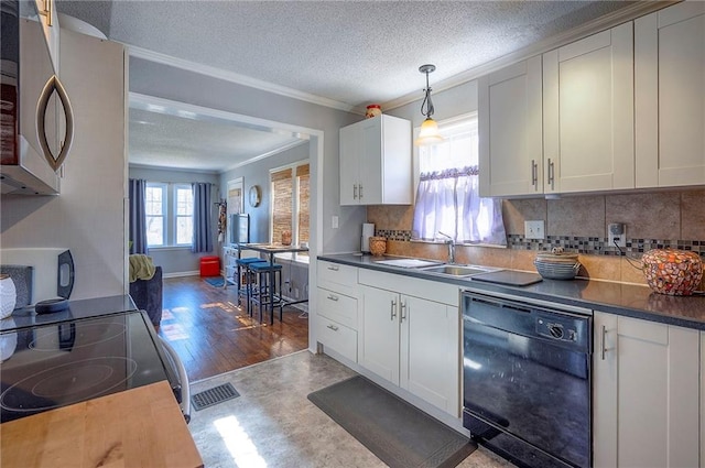 kitchen featuring black appliances, ornamental molding, a sink, a textured ceiling, and white cabinetry