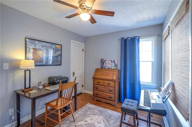 office featuring baseboards, a textured ceiling, ceiling fan, and wood finished floors