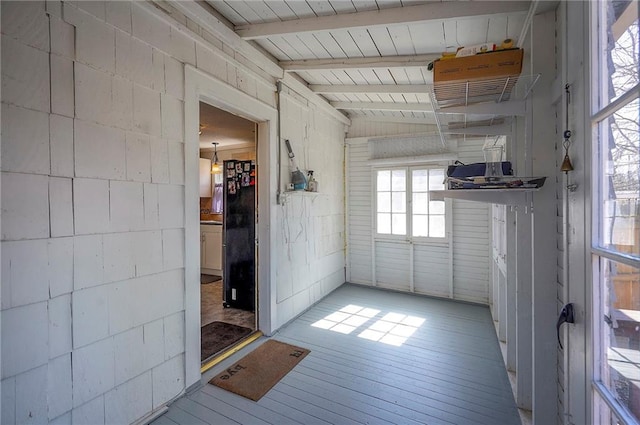 empty room featuring beamed ceiling and hardwood / wood-style floors