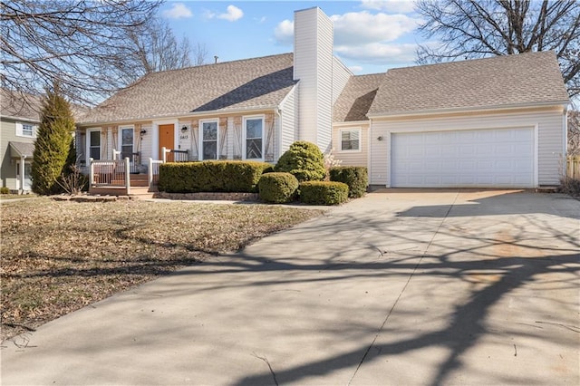 view of front of property with driveway, a chimney, an attached garage, and roof with shingles