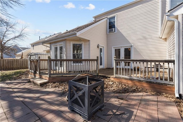 deck featuring a patio area, a fire pit, and fence