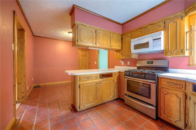 5200 NW Valley View Rd, Blue Springs, MO 64015 - kitchen with white microwave, stainless steel gas range oven, a peninsula, light countertops, and a textured ceiling