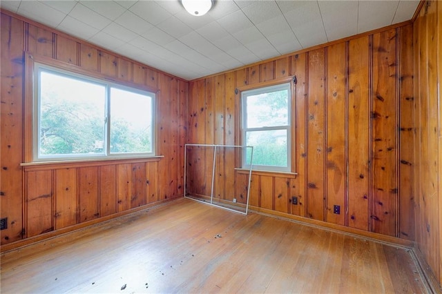 5200 NW Valley View Rd, Blue Springs, MO 64015 - empty room with hardwood / wood-style flooring, wood walls, and baseboards