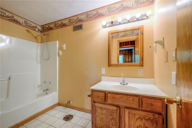 5200 NW Valley View Rd, Blue Springs, MO 64015 - full bath with vanity, tile patterned floors, shower / washtub combination, baseboards, and a textured ceiling