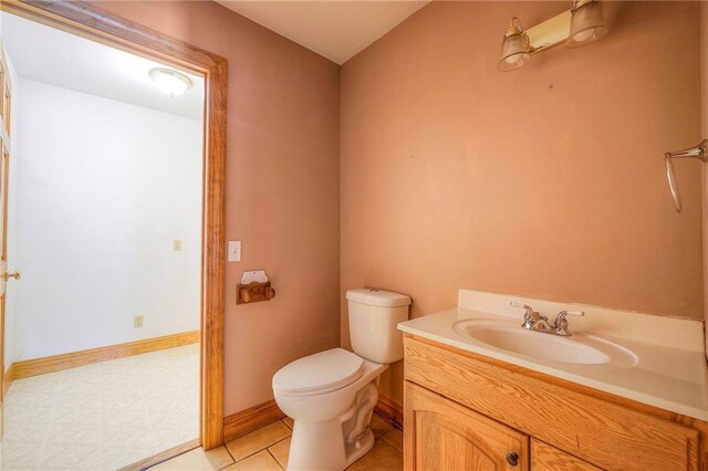 5200 NW Valley View Rd, Blue Springs, MO 64015 - bathroom featuring toilet, vanity, and baseboards