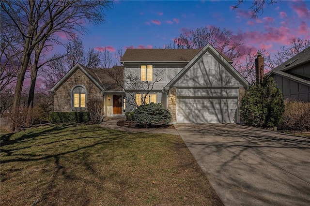 english style home featuring concrete driveway, stone siding, and a front lawn