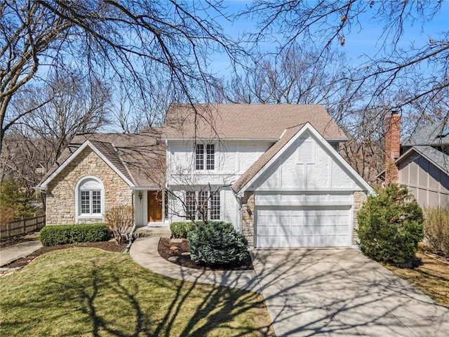 view of front facade with concrete driveway, fence, stone siding, and a front yard