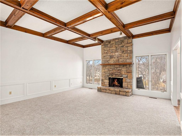 unfurnished living room featuring beamed ceiling, coffered ceiling, and carpet