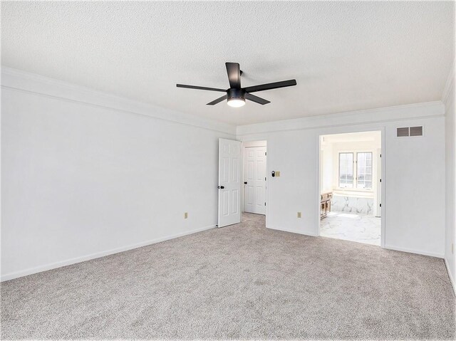 unfurnished room with visible vents, a ceiling fan, a textured ceiling, carpet, and crown molding