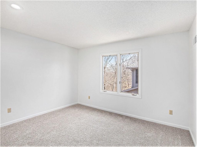 unfurnished room with recessed lighting, a textured ceiling, baseboards, and carpet