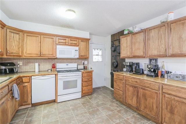 kitchen with white appliances, light countertops, and backsplash