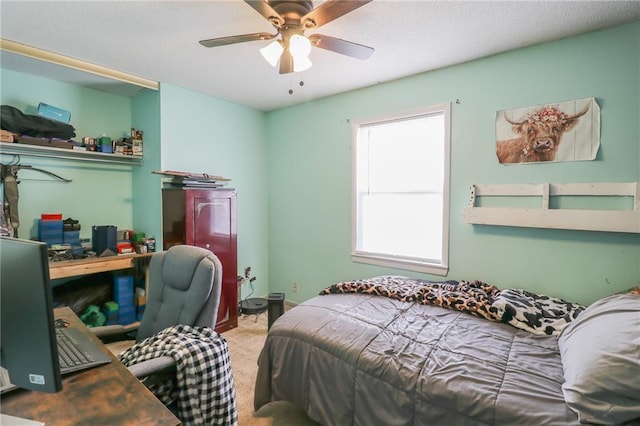 bedroom featuring carpet floors, ceiling fan, and a textured ceiling