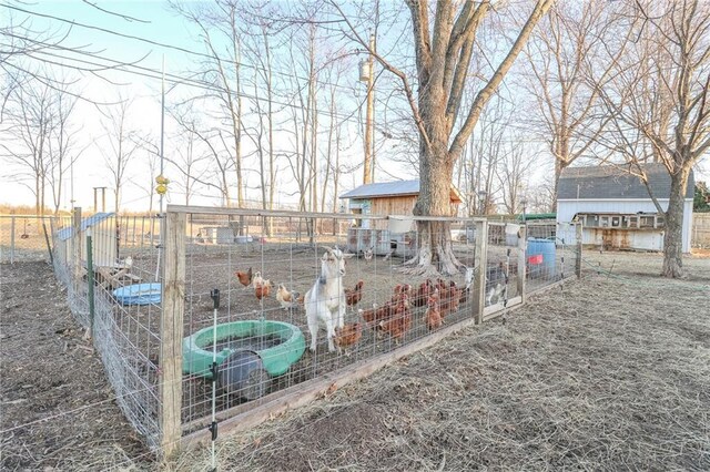 view of yard with an outbuilding and fence