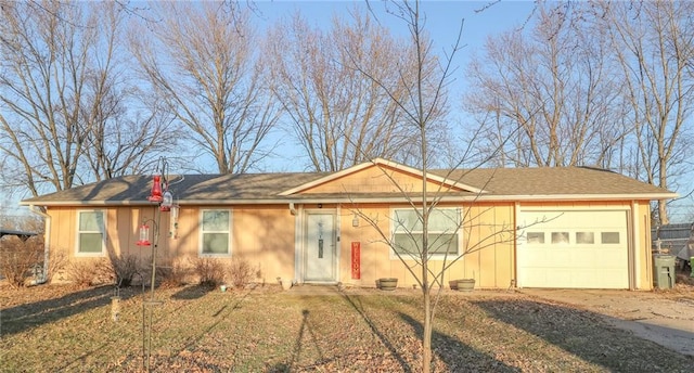 ranch-style home with a garage and driveway