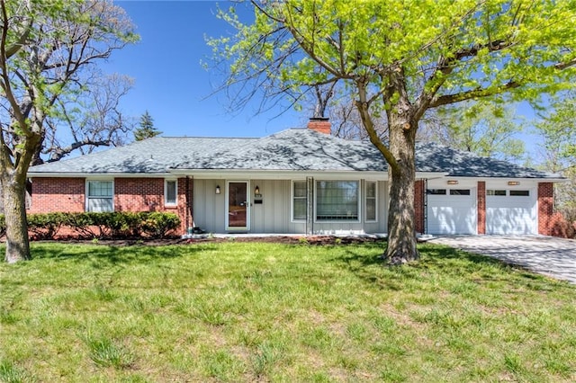 ranch-style house with driveway, a front lawn, a garage, brick siding, and a chimney