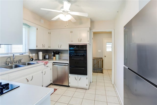 kitchen featuring white cabinets, appliances with stainless steel finishes, a warming drawer, and a sink