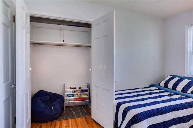 bedroom featuring a closet and wood finished floors