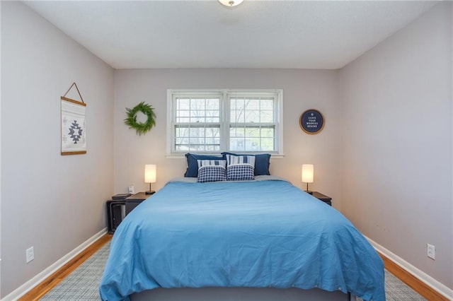 bedroom featuring baseboards and wood finished floors