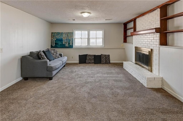 unfurnished living room featuring a brick fireplace, baseboards, carpet floors, and a textured ceiling