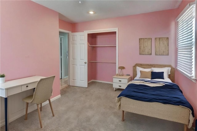 bedroom featuring multiple windows, baseboards, and carpet floors