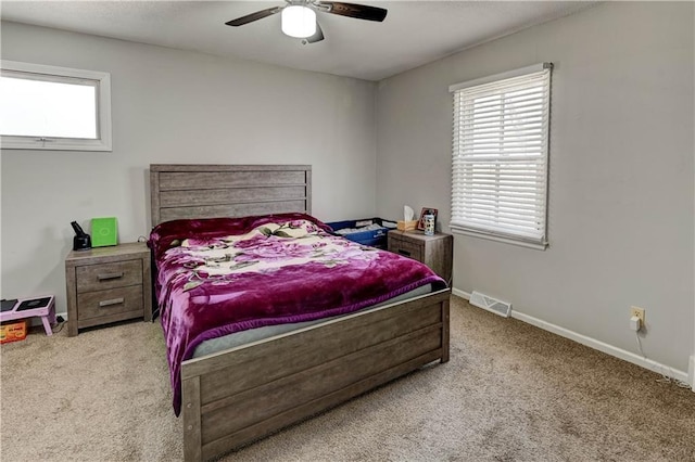 bedroom with baseboards, multiple windows, carpet, and visible vents