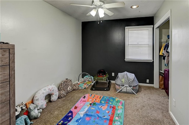 playroom featuring ceiling fan, baseboards, and carpet floors