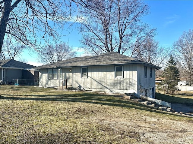 exterior space with a garage and a lawn