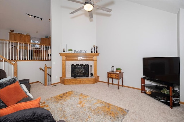 living area with track lighting, carpet flooring, a ceiling fan, and baseboards