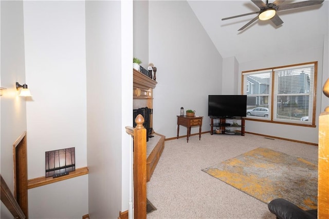 living room featuring high vaulted ceiling, baseboards, carpet floors, and ceiling fan