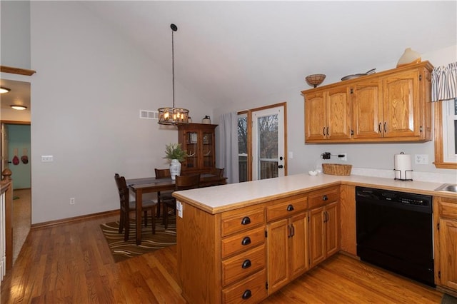 kitchen with visible vents, light wood-style flooring, a peninsula, light countertops, and dishwasher