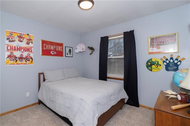 bedroom featuring baseboards and carpet floors