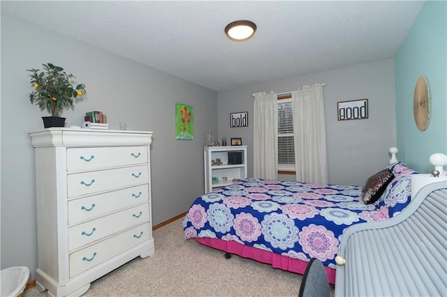 bedroom featuring carpet and baseboards