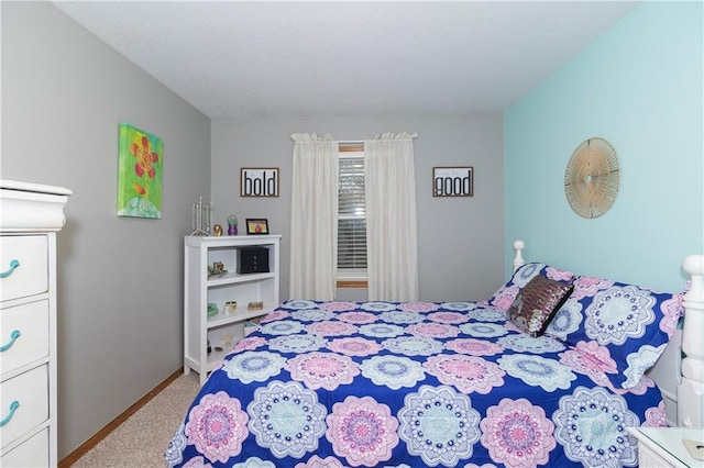 carpeted bedroom featuring baseboards