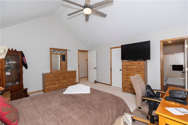 bedroom featuring baseboards, high vaulted ceiling, ceiling fan, ensuite bathroom, and carpet flooring