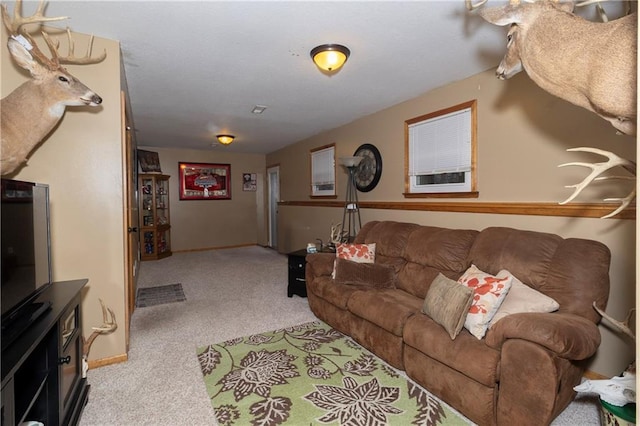 carpeted living area with baseboards