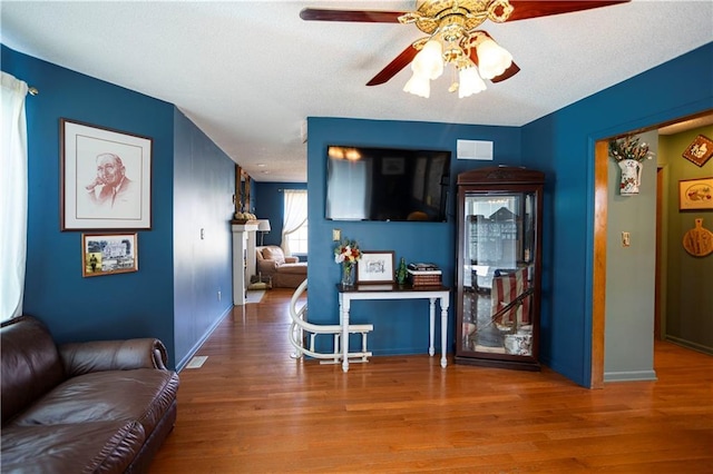 interior space featuring wood finished floors, a ceiling fan, and baseboards